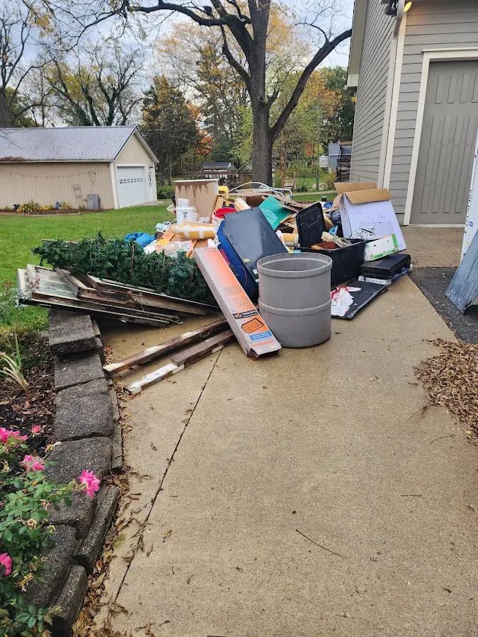 Dumpster being loaded with debris for Estate Cleanout Dumpster Rental in Bethel Acres